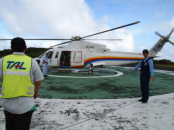 A police officer standing in front of the helicopter